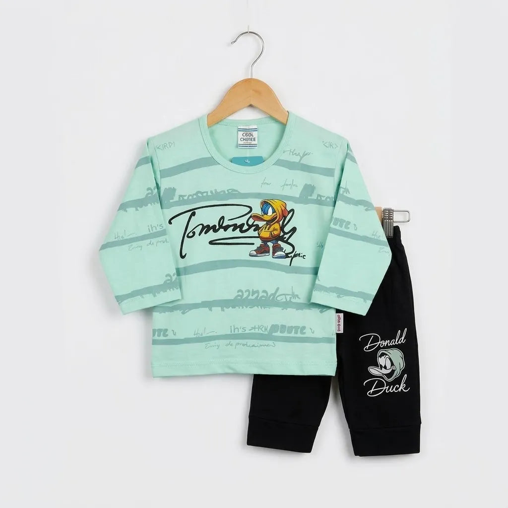 A children's two-piece outfit set featuring a mint green long-sleeve top with a cartoon graphic and black pants, displayed on a wooden hanger against a white background.
