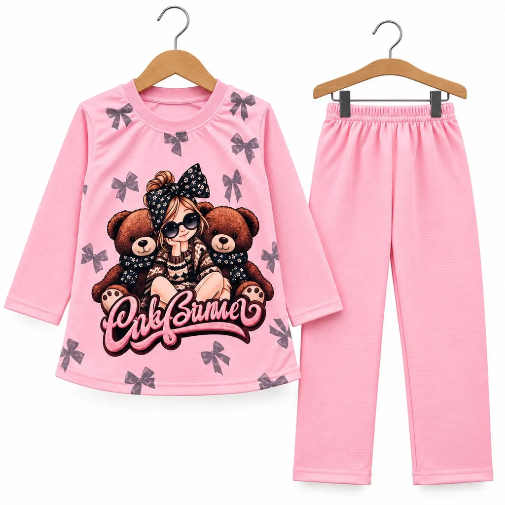 A two-piece children's pajama set on wooden hangers, featuring a long-sleeve pink top with a cartoon girl, teddy bears, and bow print, and matching pink pants.